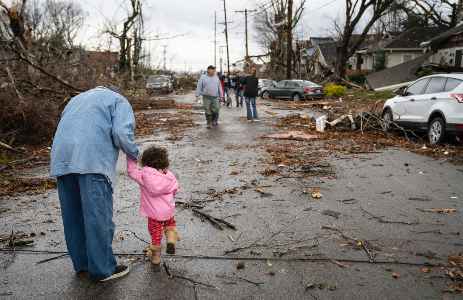 Residents of Bowling Green, Ky., survey damage on a neighborhood street. Severe storms ripped through five states killing dozens of people in the wee hours of Saturday morning.
This photo is being used for non-commercial purpose and not in connection with selling a good or service.